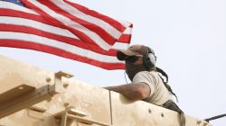 A member of U.S forces rides on a military vehicle in the town of Darbasiya next to the Turkish border, Syria April 28, 2017. REUTERS/Rodi Said