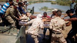 A wounded displaced man is evacuated by Iraqi forces as he crosses the Tigris by a military boat after the bridge has been temporarily closed, south of Mosul, Iraq May 4, 2017. REUTERS/Suhaib Salem