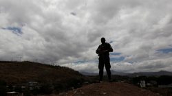 A member of the military police keeps watch during a routine foot patrol at El Pedregal neighbourhood Tegucigalpa, Honduras, May 3, 2017. REUTERS/Jorge Cabrera