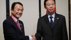 Chinese Finance Minister Xiao Jie (R) and Japanese Finance Minister Taro Aso shake hands during their bilateral meeting, on the sidelines of Asian Development Bank (ADB) annual meeting, in Yokohama, Japan, Saturday, May 6, 2017. REUTERS/Koji Sasahara/Pool