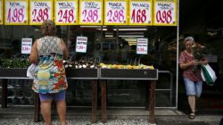 FILE PHOTO: A woman looks on prices at a food market in Rio de Janeiro, Brazil, January 21, 2016. REUTERS/Pilar Olivares/File Photo
