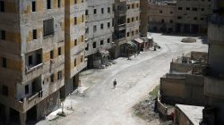 Abu Malek, one of the survivors of a chemical attack in the Ghouta region of Damascus that took place in 2013, uses his crutches to walk along a street in the Ghouta town of Ain Tarma, Syria. REUTERS/Bassam Khabieh