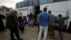Passengers wait in Qamishli city in Syria's Kurdish-held northeast to embark on a bus headed for government-controlled Aleppo, Syria May 7, 2017. REUTERS/Rodi Said