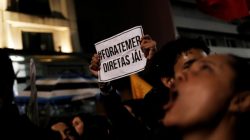 Demonstrators shout slogans during a protest against Brazil's President Michel Temer in Sao Paulo, Brazil, May 18, 2017. The sign reads "Out Temer and Elections now!." REUTERS/Nacho Doce