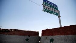 FILE PHOTO: A road sign that shows the direction to Homs is seen in Damascus, Syria April 7, 2017. REUTERS/Omar Sanadiki
