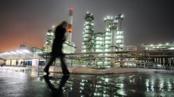 A man walks in front of the Novokuibyshevsk refinery near the city of Samara, October 28, 2010. REUTERS/Nikolay Korchekov/File Photo