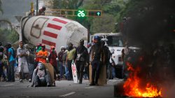 Demonstrators stand near a truck as they use it as a barricade while clashing with riot security forces during a rally called by healthcare workers and opposition activists against Venezuela's President Nicolas Maduro in Caracas. REUTERS/Carlos Barria