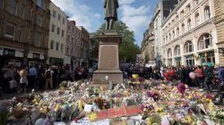 Messages and floral tributes left for the victims of the attack on Manchester Arena lie around the statue in St Ann's Square in central Manchester, May 24, 2017. REUTERS/Jon Super