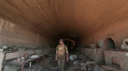 FILE PHOTO: A Syrian Democratic Forces (SDF) fighter inspects a damaged building inside Tabqa military airport after taking control of it from Islamic State fighters, west of Raqqa city, Syria April 9, 2017. REUTERS/Rodi Said/File Photo