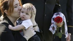 FILE PHOTO: Widow Alexandra McClintock holds her son Declan during a burial service for her husband, U.S. Army Sergeant First Class Matthew McClintock, who was killed in action in January at Arlington National Cemetery in Virginia March 7, 2016. REUTERS/Gary Cameron/File Photo