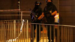 Armed police officers stand next to a police cordon outside the Manchester Arena, where U.S. singer Ariana Grande had been performing, in Manchester, northern England, Britain, May 23, 2017. REUTERS/Andrew