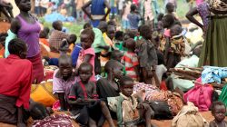 FILE PHOTO: South Sudanese refugees gather with their belongings after crossing into Uganda at the Ngomoromo border post in Lamwo district, northern Uganda, April 4, 2017. REUTERS/Stringer/File photo