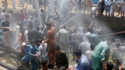 People cool off with water from water lines after they punctured them in protest against the power outages in their area in Karachi, Pakistan May 30, 2017. REUTERS/Akhtar Soomro