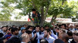Relatives of victims listen to hospital officials after a blast in Kabul.