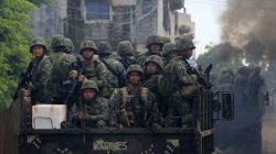 Soldiers onboard military trucks ride along the main street as government troops continue their assault on insurgents from the Maute group, who have taken over large parts of Marawi City, Philippines. REUTERS/Romeo Ranoco