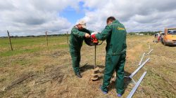 Workers drill a hole for a fence near the Sudargas border crossing point with Russia in Ramoniskiai, Lithuania June 5, 2017