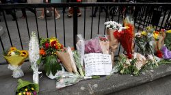 Commuters walk past flowers and messages left outside Monument Underground station next to London Bridge. REUTERS/Peter Nicholls
