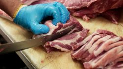 FILE PHOTO: Canadian pork shoulders are being prepped on a butcher's counter at North Hill Meats in Toronto, Ontario, Canada on May 10, 2017. Picture taken on May 10, 2017. REUTERS/Hyungwon Kang/File Photo