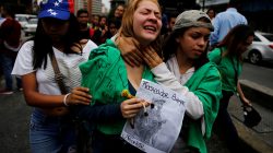 A woman reacts at the place where 17-year-old demonstrator Neomar Lander died during riots at a rally against Venezuelan President Nicolas Maduro's government in Caracas, Venezuela, June 8, 2017. The sign reads: "Neomar, entertainer for ever". REUTERS/Ivan Alvarado