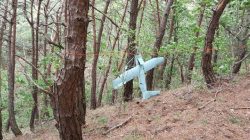 A small aircraft what South Korea's Military said is believed to be a North Korean drone, is seen at a mountain near the demilitarised zone separating the two Koreas in Inje, South Korea in this handout picture provided by the Defence Ministry and released by News1 on June 9, 2017. The Defence Ministry/News1 via REUTERS