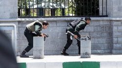 Members of Iranian forces take cover during an attack on the Iranian parliament in central Tehran, Iran, June 7, 2017. Tasnim News Agency/Handout via REUTERS