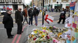 People look at floral tributes near London Bridge, London, Britain, June 8, 2017. REUTERS/Marko Djurica