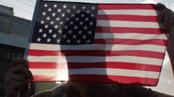 A man holds a U.S. flag after the economically struggling U.S. island territory of Puerto Rico voted overwhelmingly on Sunday in favour of becoming the 51st state, in San Juan, Puerto Rico June 11, 2017