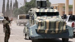 A Syrian Democratic Forces (SDF) fighter gestures towards an armoured vehicle in Hawi Hawa village, west of Raqqa, Syria June 11, 2017. REUTERS/Rodi Said