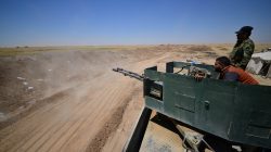 Popular Mobilization Forces (PMF) ride in a military vehicle on the Iraqi border with Syria, west of Mosul, Iraq June 12, 2017. REUTERS/Stringer
