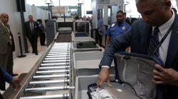 A TSA official removes a laptop from a bag for scanning using the Transport Security Administration's new Automated Screening Lane technology at Terminal 4 of JFK airport in New York City, U.S., May 17, 2017. REUTERS/Joe Penney