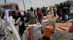 Civilians are handed out sacs of wheat and sugar in western Mosul, Iraq June 14, 2017. REUTERS/Alkis Konstantinidis