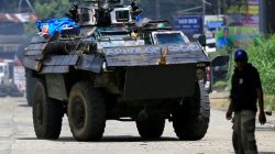 An armoured personnel carrier (APC) drives along the road of Amai Pakpak, as government troops continue their assault against insurgents from the Maute group, who have taken over large parts of Marawi city, Philippines. REUTERS/Romeo Ranoco