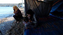 Faten 25, (L) from Syria, sits at the edge of the beach beside her sister-in-law near their tent outside the Souda refugees camp in Chios Island, Greece, June 10, 2017. "It's taking too long. This slowness to reunite families scares me," Faten said. "We have nothing to do all day long, we just sit by the tent which I share with my sister-in-law, a friend and her daughter."