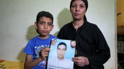 Hanaa Youssef and Mina Habib, the widow and son of a man who was killed in a militant attack against Coptic Christians last month, hold the victim's portrait in Minya, Egypt June 8, 2017. Picture taken June 8, 2017. REUTERS/Mohamed Abd El Ghany