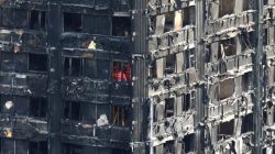 Members of the emergency services work inside burnt out remains of the Grenfell apartment tower in North Kensington, London. REUTERS/Neil Hall
