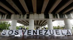 A banner is seen with a small group of Venezuelan protesters outside the site where the Organization of American States (OAS) 47th General Assembly is taking place in Cancun, Mexico June 21, 2017. REUTERS/Carlos Jasso