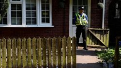 A police officer stands outside the home of Darren Osborne, in Cardiff, Wales June 20, 2017. REUTERS/Rebecca Naden