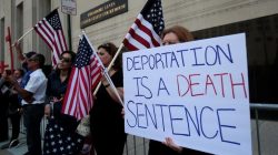 Protesters rally outside the federal court just before a hearing to consider a class-action lawsuit filed on behalf of Iraqi nationals facing deportation, in Detroit, Michigan, U.S., June 21, 2017. REUTERS/Rebecca Cook