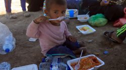 A displaced Iraqi child eats after fleeing with his family during the fights between the Iraqi army and Islamic State militants, in the old city in Mosul, Iraq June 26, 2017.