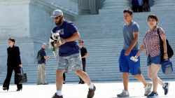 People walk outside the the U.S. Supreme Court building after the Court granted parts of the Trump administration's emergency request to put his travel ban into effect immediately while the legal battle continues, in Washington, U.S., June 26, 2017