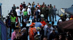 Rescuers wait at the dock after a tourist boat sank with 150 passengers onboard at the Guatape reservoir, Colombia, June 25, 2017