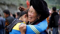 Relatives of victims react at the site of a landslide in the village of Xinmo, Mao County, Sichuan Province, China June 26, 2017.