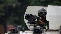 FILE PHOTO: A member of the national guard looks on atop a vehicle during clashes with opposition supporters while rallying against Venezuela's President Nicolas Maduro in Caracas, Venezuela, April 20, 2017. REUTERS/Carlos Garcia Rawlins