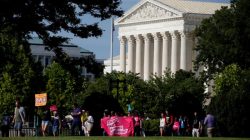 FILE PHOTO: Healthcare activists with Planned Parenthood and the Center for American Progress pass by the Supreme Court as they protest in opposition to the Senate Republican healthcare bill on Capitol Hill in Washington, U.S., June 28, 2017. REUTERS/Joshua Roberts/File Photo
