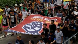 Pro-democracy protesters carry a banner which reads "One Country, Two Systems, a cheating for twenty years. Recapture Hong Kong with democracy and self-determination", during a demonstration on the 20th anniversary of the territory's handover from Britain to Chinese rule, in Hong Kong, China July 1, 2017. REUTERS/Bobby Yip