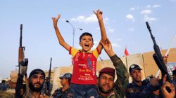 Members of Iraqi Federal Police carry a boy as they celebrate victory of military operations against the Islamic State militants in West Mosul, Iraq July 2, 2017.
