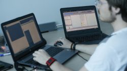 A view shows a laptop display (R) showing part of a code, which is the component of Petya malware computer virus according to representatives of Ukrainian cyber security firm ISSP, with an employee working nearby at the firm's office in Kiev, Ukraine July 4, 2017. REUTERS/Valentyn Ogirenko