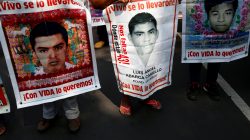 FILE PHOTO: Relatives hold posters with images of some of the 43 missing students of Ayotzinapa College Raul Isidro Burgos as they take part in a march to mark National Teachers' Day along Reforma avenue, in Mexico City, Mexico May 15, 2017. REUTERS/Henry Romero/File Photo