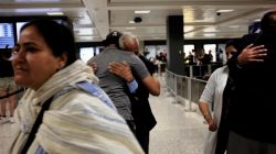people hugging; travel ban