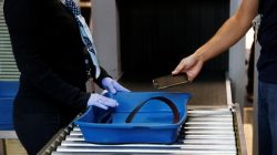 Staff demonstrate the flow of passengers as they queue to X-ray shoes, mobile phone and bags at the security gates at Cointrin airport in Geneva, Switzerland, November 24, 2016. REUTERS/Denis Balibouse